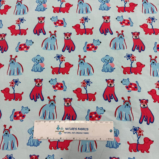 Nature's Fabrics light blue cotton fabric with red and blue patriotic dogs pattern.