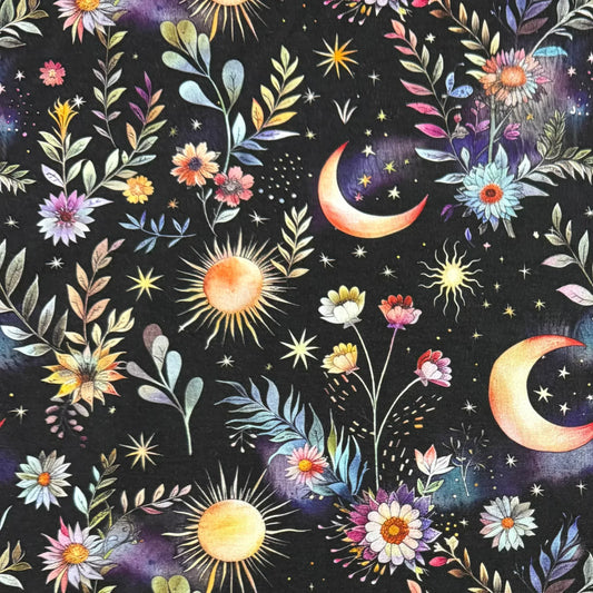 Nature's Fabrics celestial pattern with suns, moons, and colorful flowers on black background.