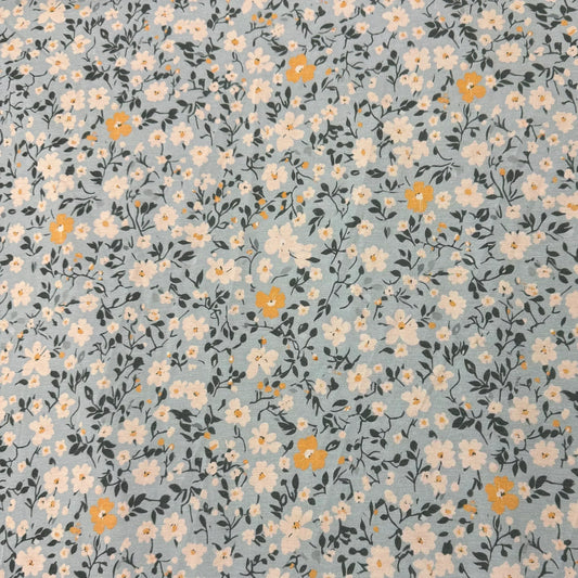 Nature's Fabrics light blue cotton fabric with white and yellow floral print
