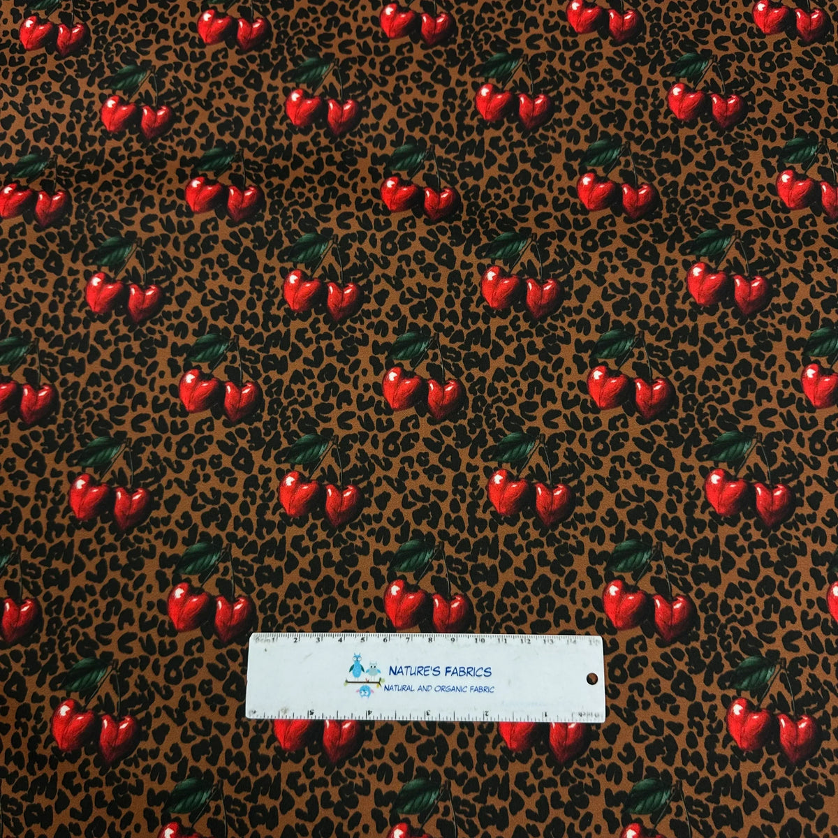 Cherry print fabric on leopard background by Nature's Fabrics, natural organic cotton yardage