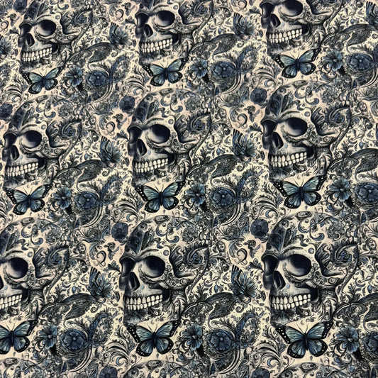 Nature's Fabrics blue and beige skull and butterfly patterned textile.