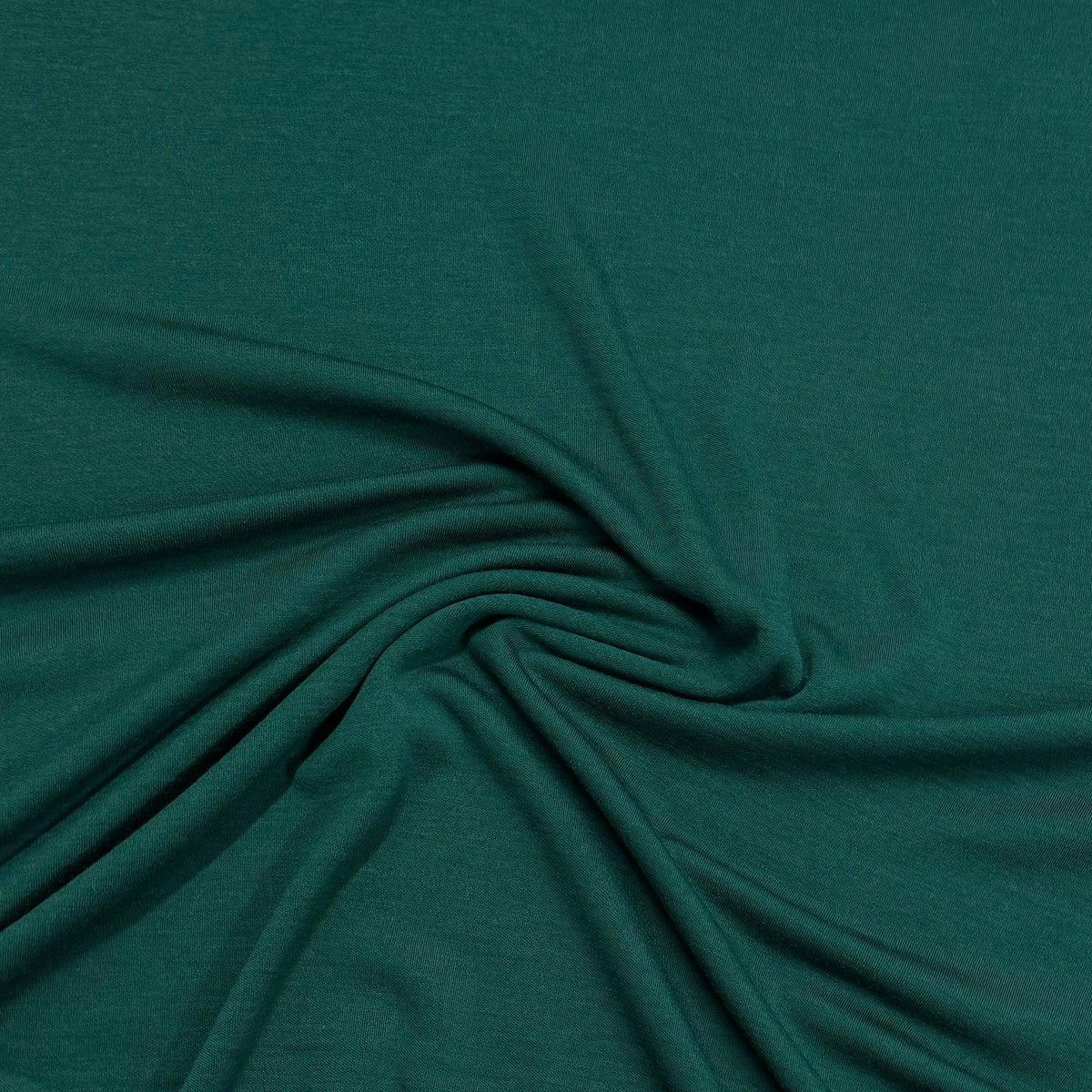 Deep green organic cotton fabric by Nature's Fabrics, soft texture and natural drape for eco-friendly sewing projects