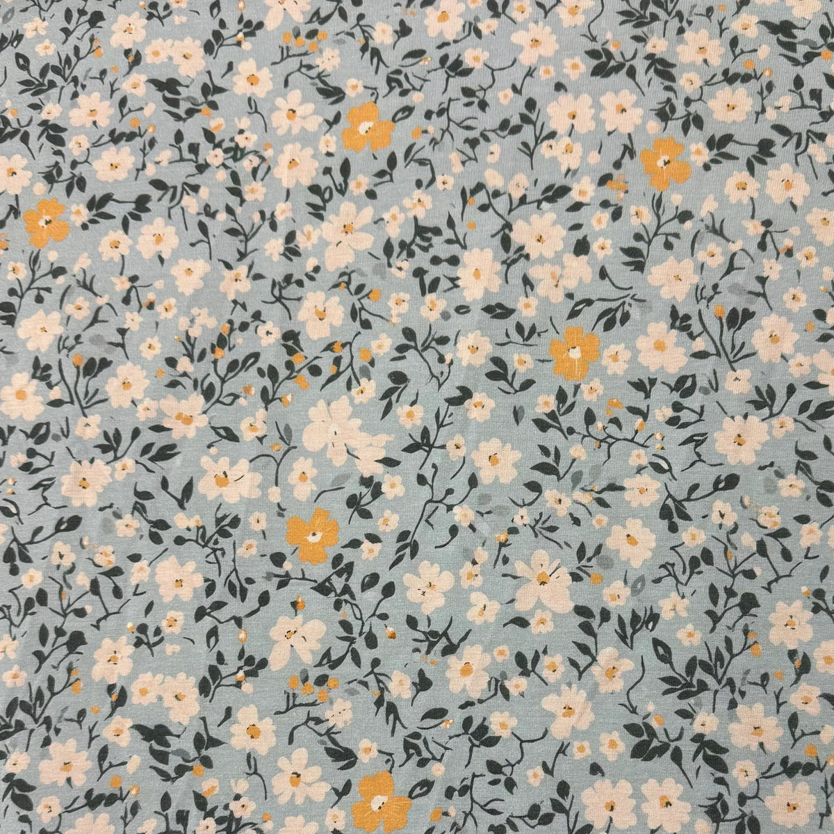 Nature's Fabrics light blue cotton fabric with white and yellow floral pattern