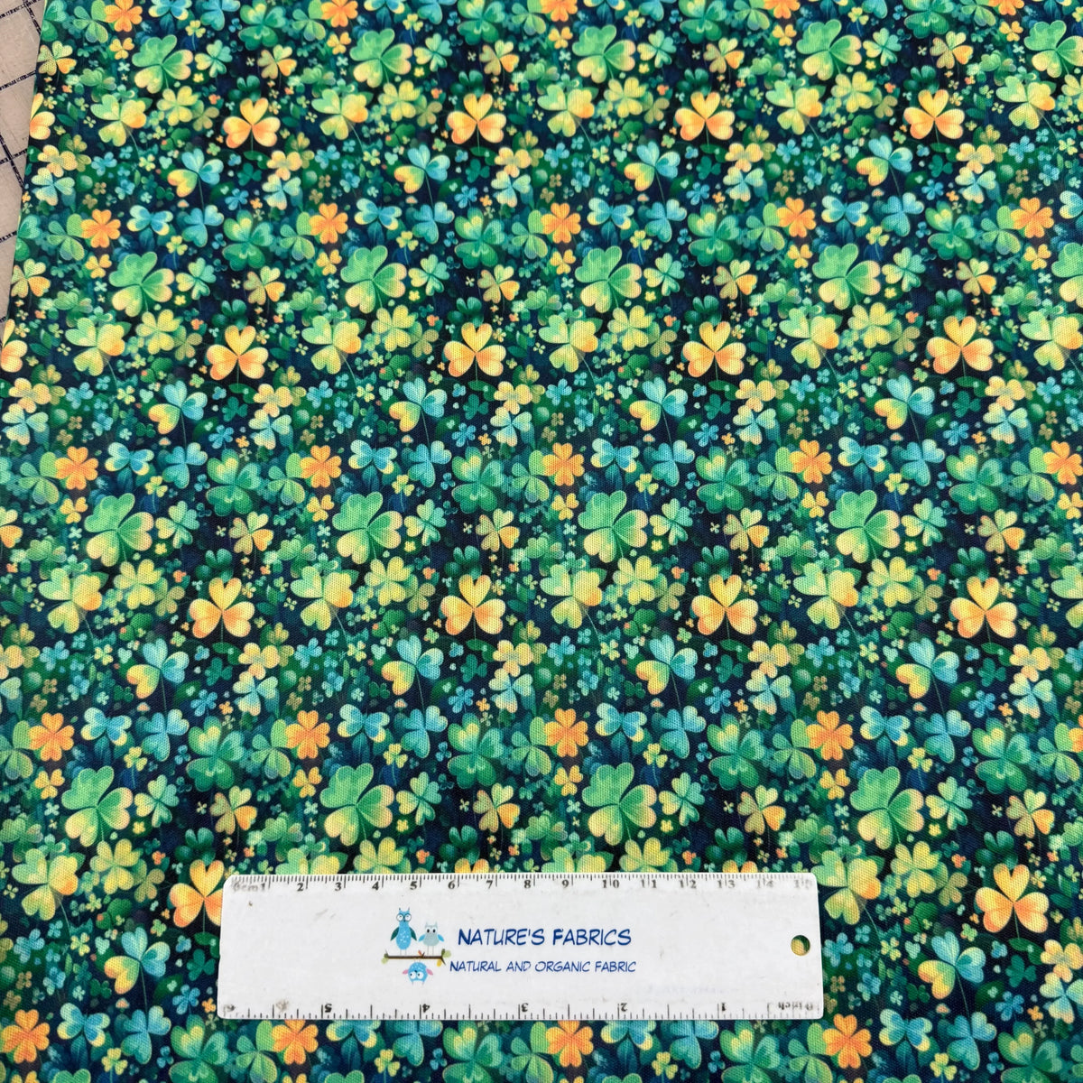 Nature's Fabrics organic cotton fabric with green and orange clover pattern, eco-friendly textile