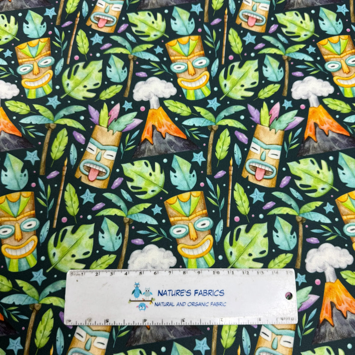 Tiki mask fabric with tropical leaves and volcanoes by Nature's Fabrics
