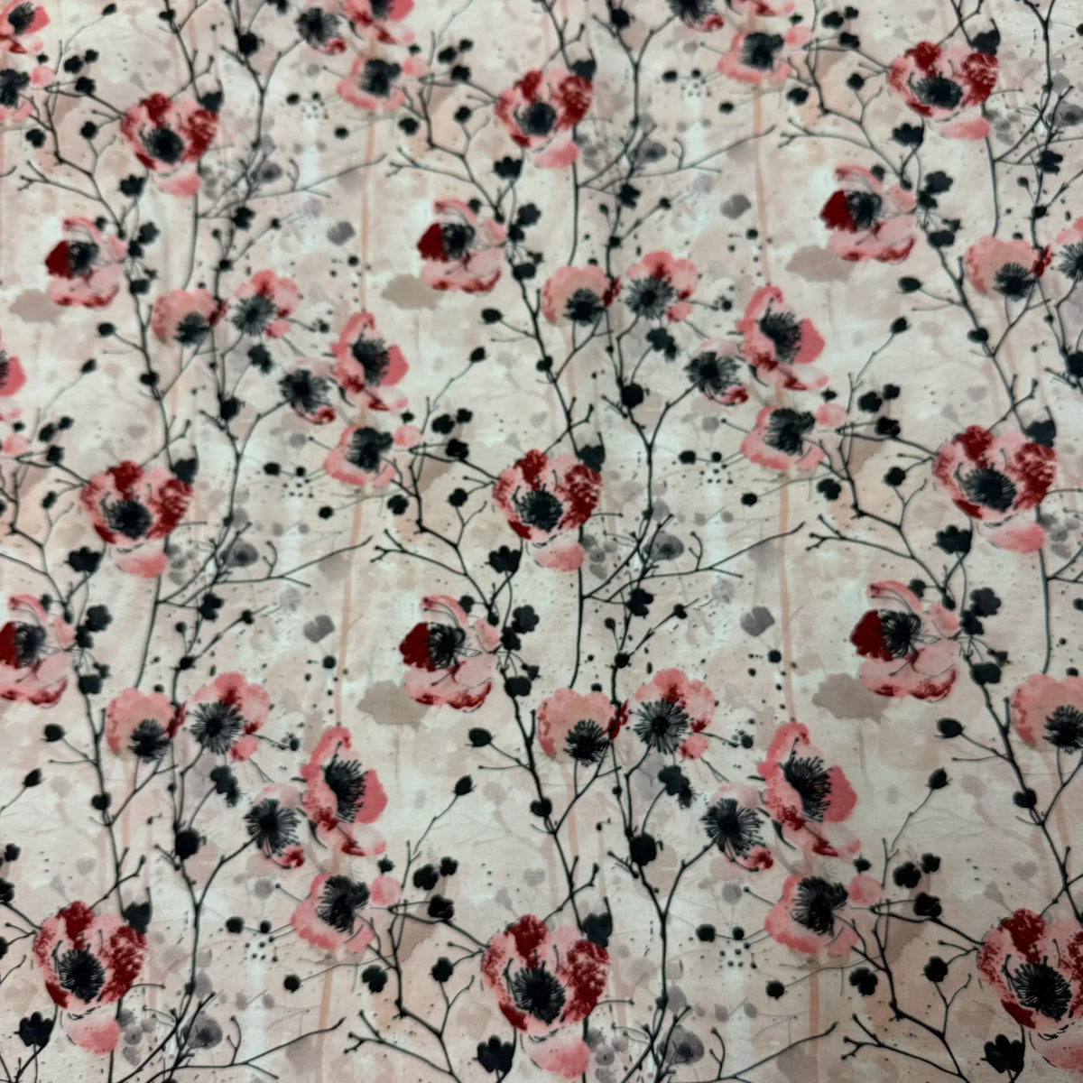 Nature's Fabrics floral print fabric featuring red and pink poppies on a light beige background