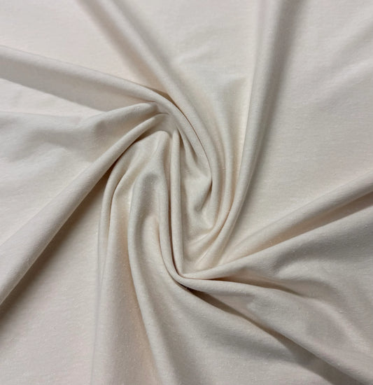 Nature's Fabrics off-white premium natural fabric draped in a spiral swirl.