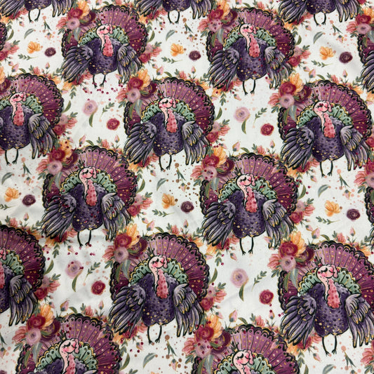Nature's Fabrics cotton fabric featuring a colorful illustrative turkey and floral pattern.