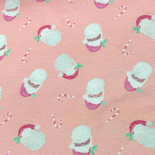Pink fabric with Santa and candy cane print by Nature's Fabrics