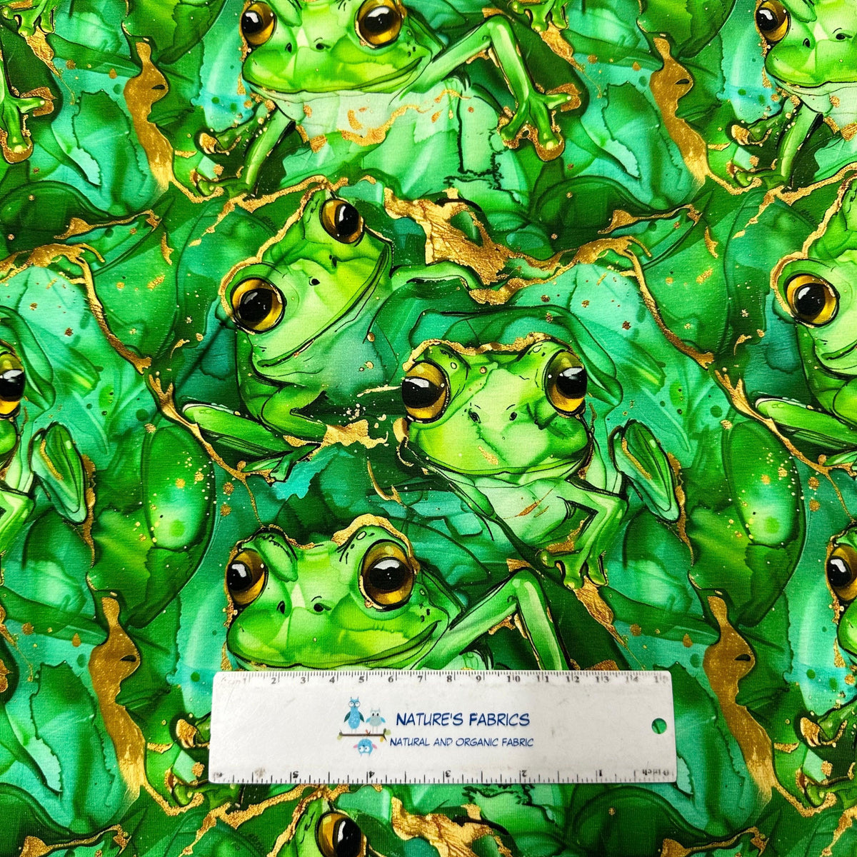 Green frog print fabric with gold accents by Nature's Fabrics, organic cotton material for crafts and sewing