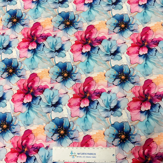 Nature's Fabrics floral print fabric featuring pink and blue blossoms on a light background.