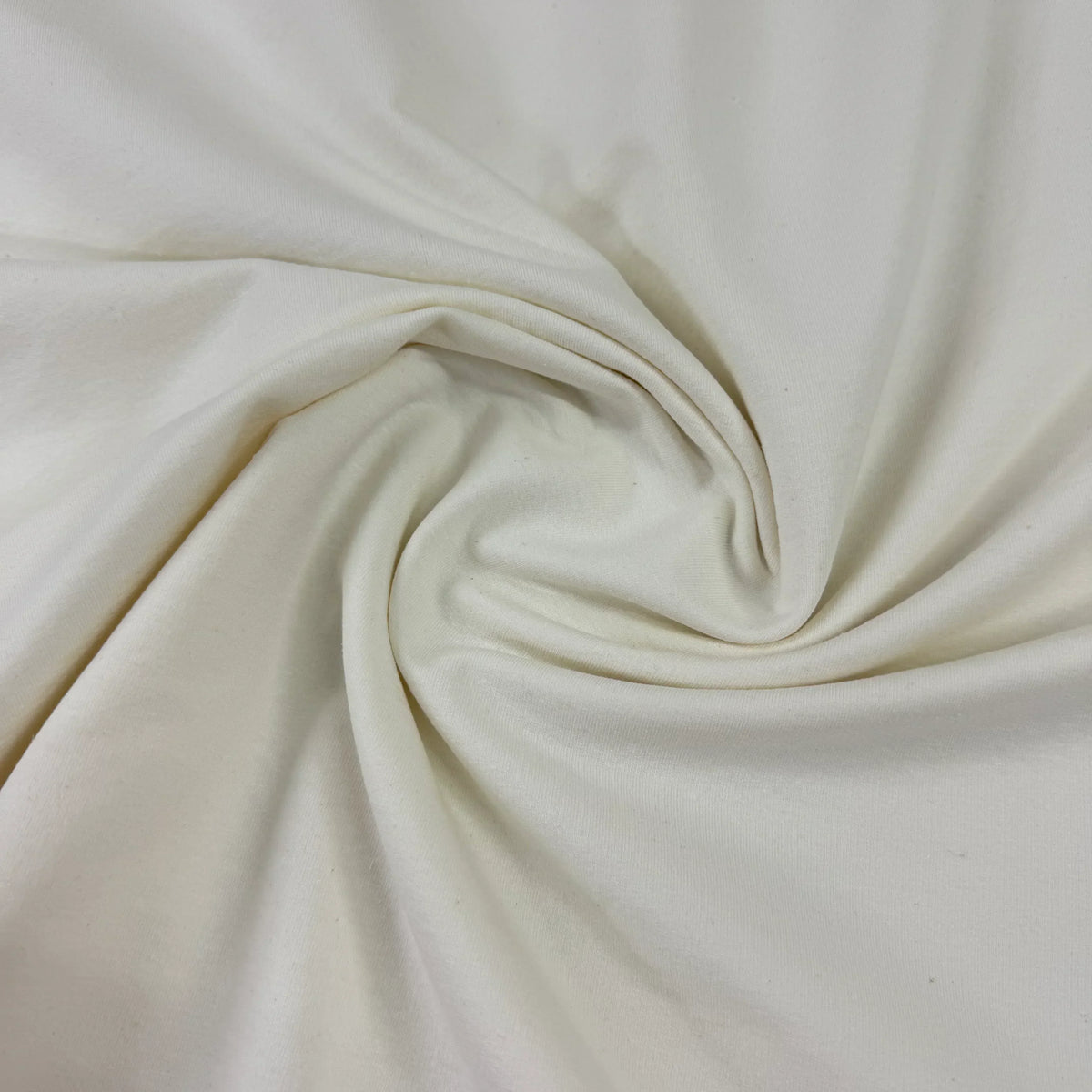 Unbleached organic cotton fabric with soft natural texture, perfect for eco-friendly sewing