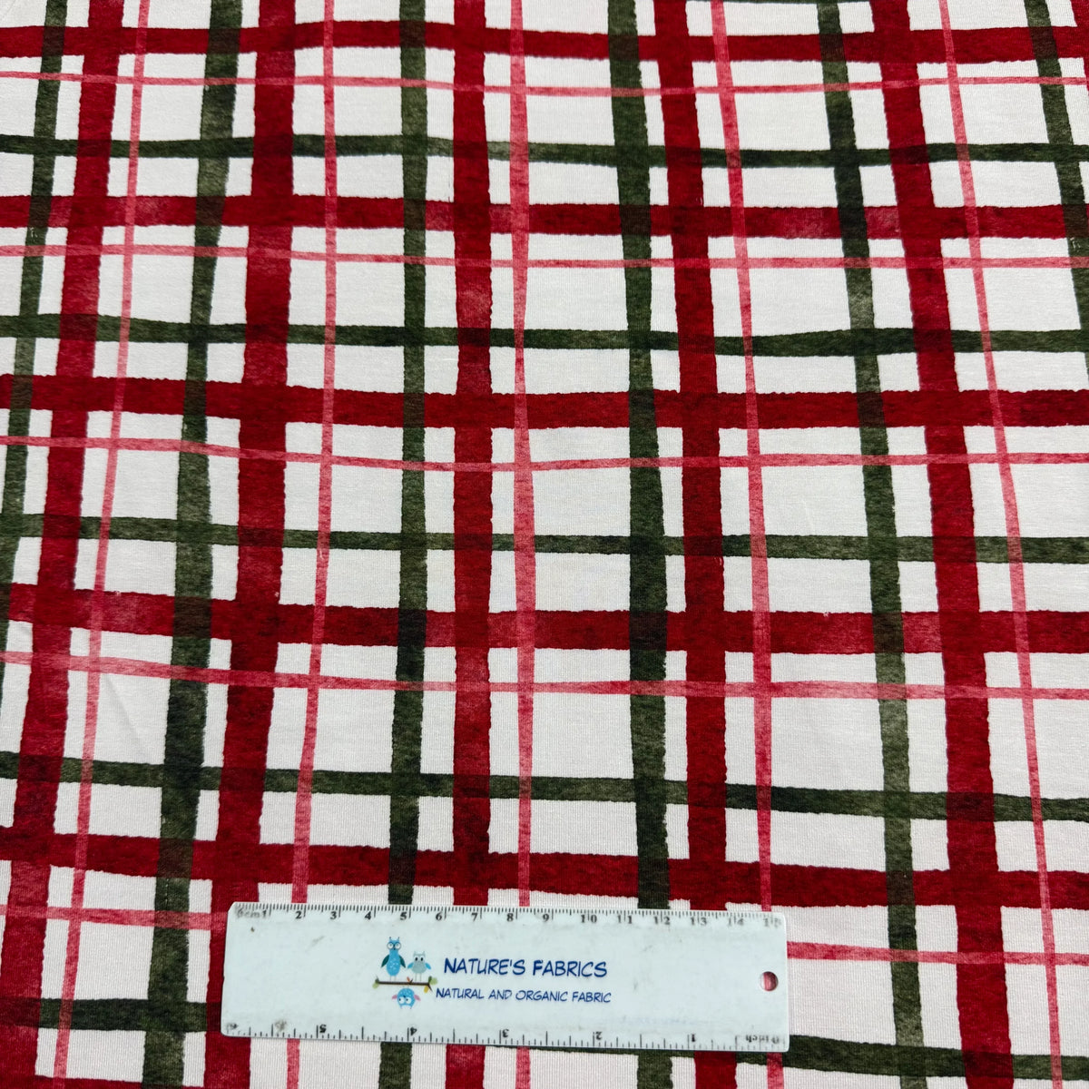 Red and green plaid fabric from Nature's Fabrics with a measuring ruler for scale.