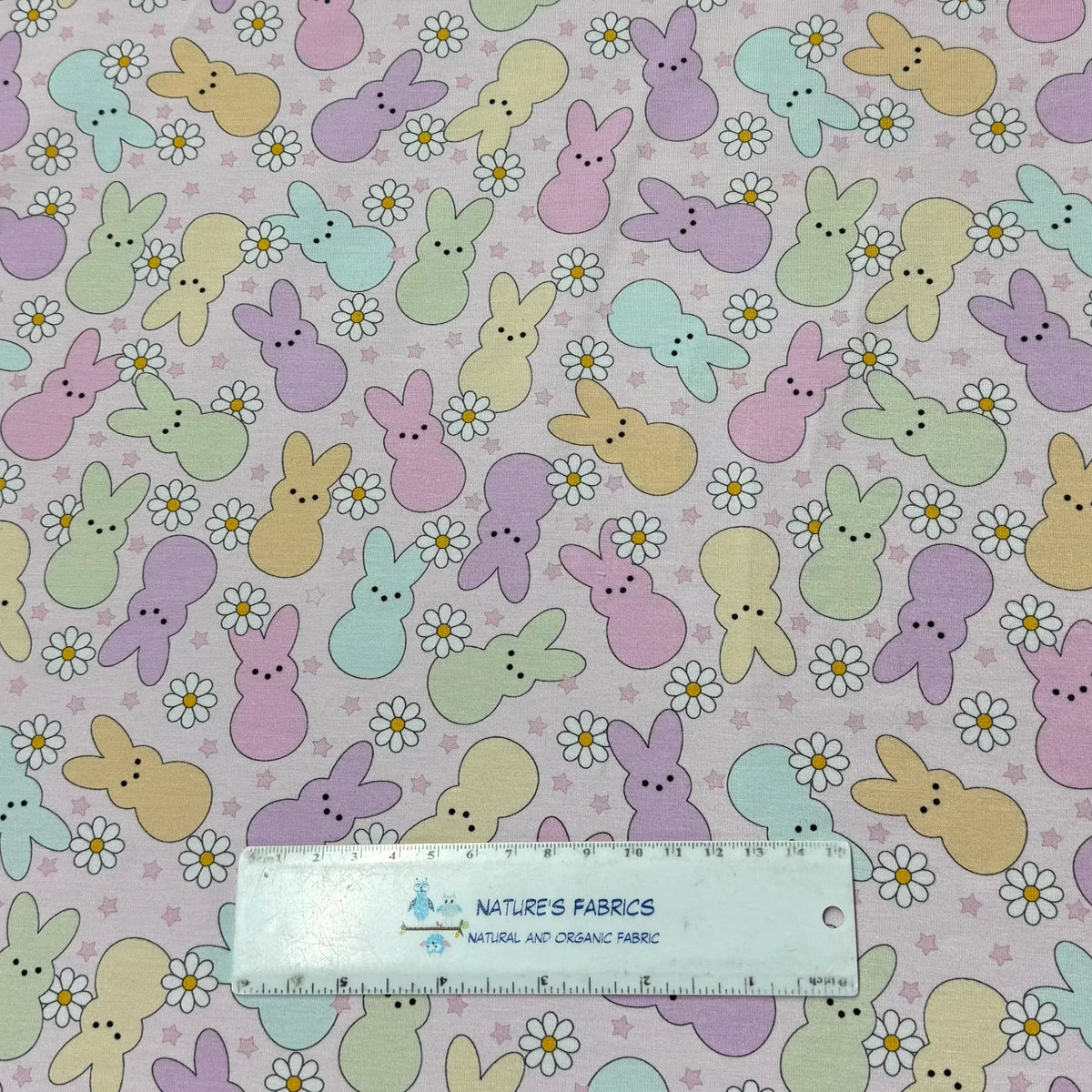 Pastel Easter bunny and daisy print fabric by Nature's Fabrics, natural organic cotton yardage with ruler for scale