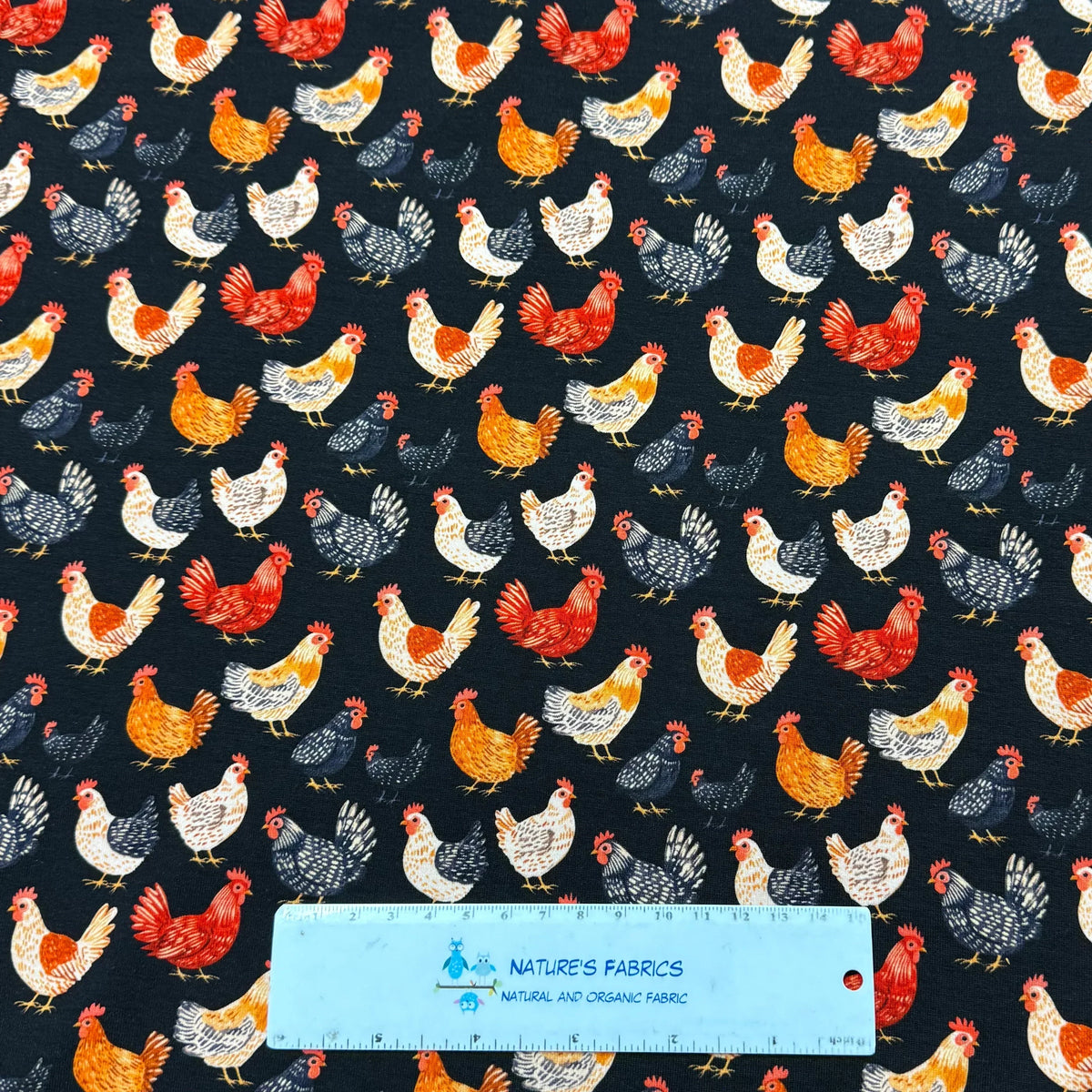 Nature's Fabrics chicken print fabric with colorful roosters on dark background, organic cotton by the yard