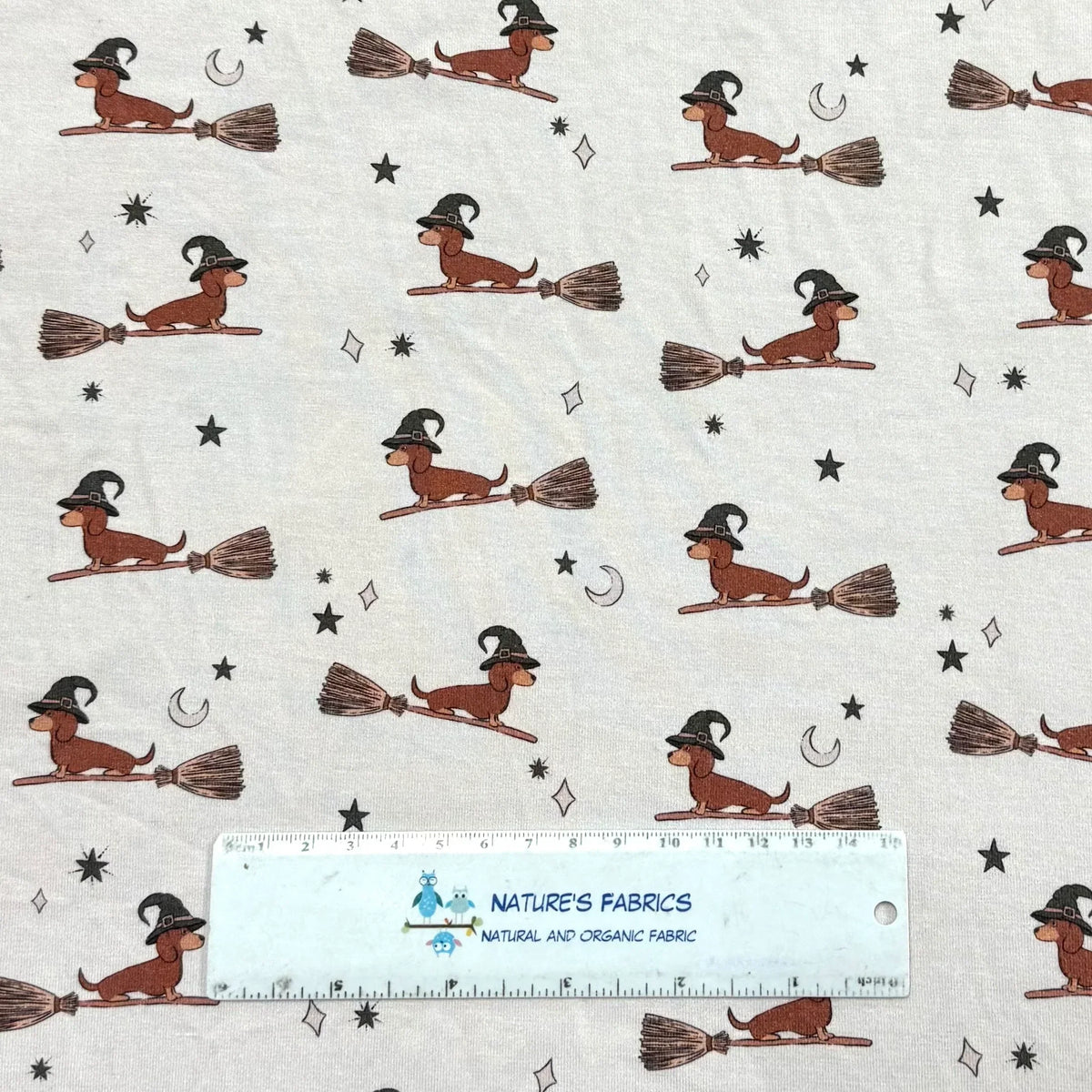 Nature's Fabrics organic cotton fabric featuring cute dachshunds as witches on broomsticks.