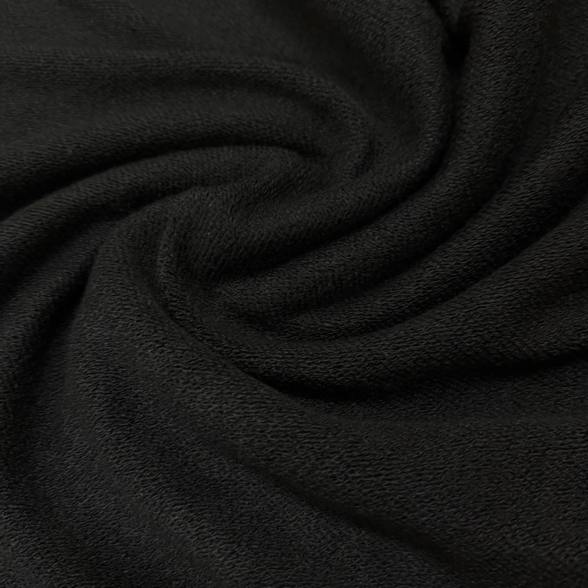 Black organic cotton fabric by Nature's Fabrics, soft texture and natural weave for eco-friendly sewing projects.