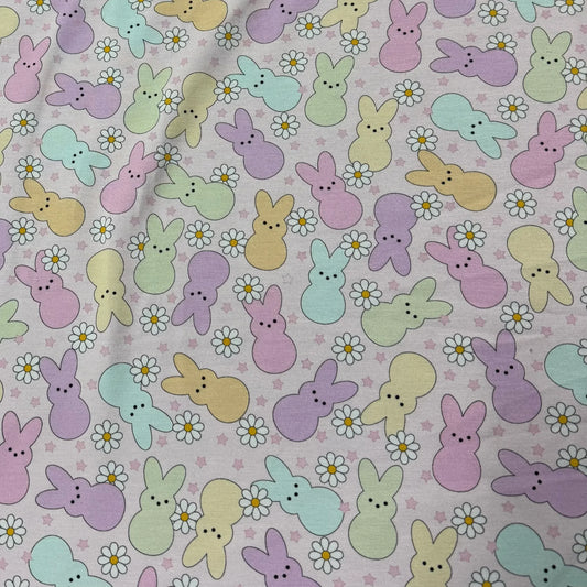 Pastel Easter bunny and daisy print fabric by Nature's Fabrics, ideal for spring crafts and sewing projects.