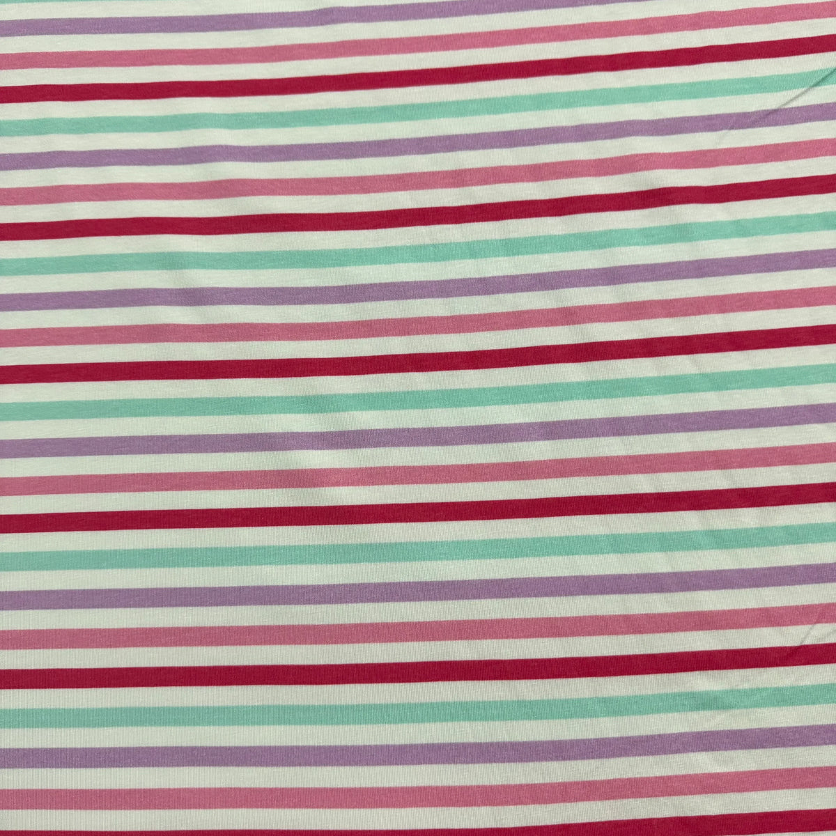 Nature's Fabrics striped organic cotton fabric with red, mint, and lavender stripes