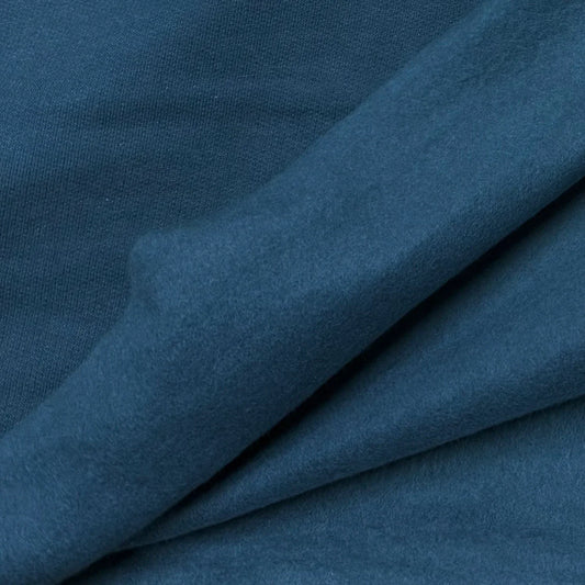 Close-up of draped teal blue natural fabric from Nature's Fabrics.
