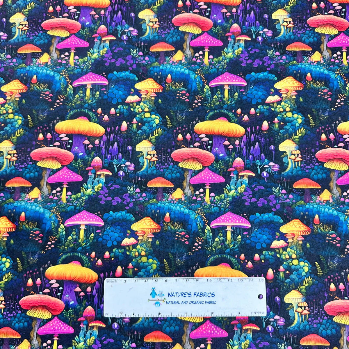 Vibrant mushroom print fabric by Nature's Fabrics, featuring colorful fungi on organic cotton.