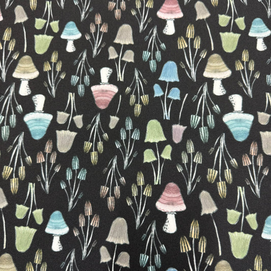 Nature's Fabrics organic cotton fabric with a colorful illustrated mushroom pattern on black.