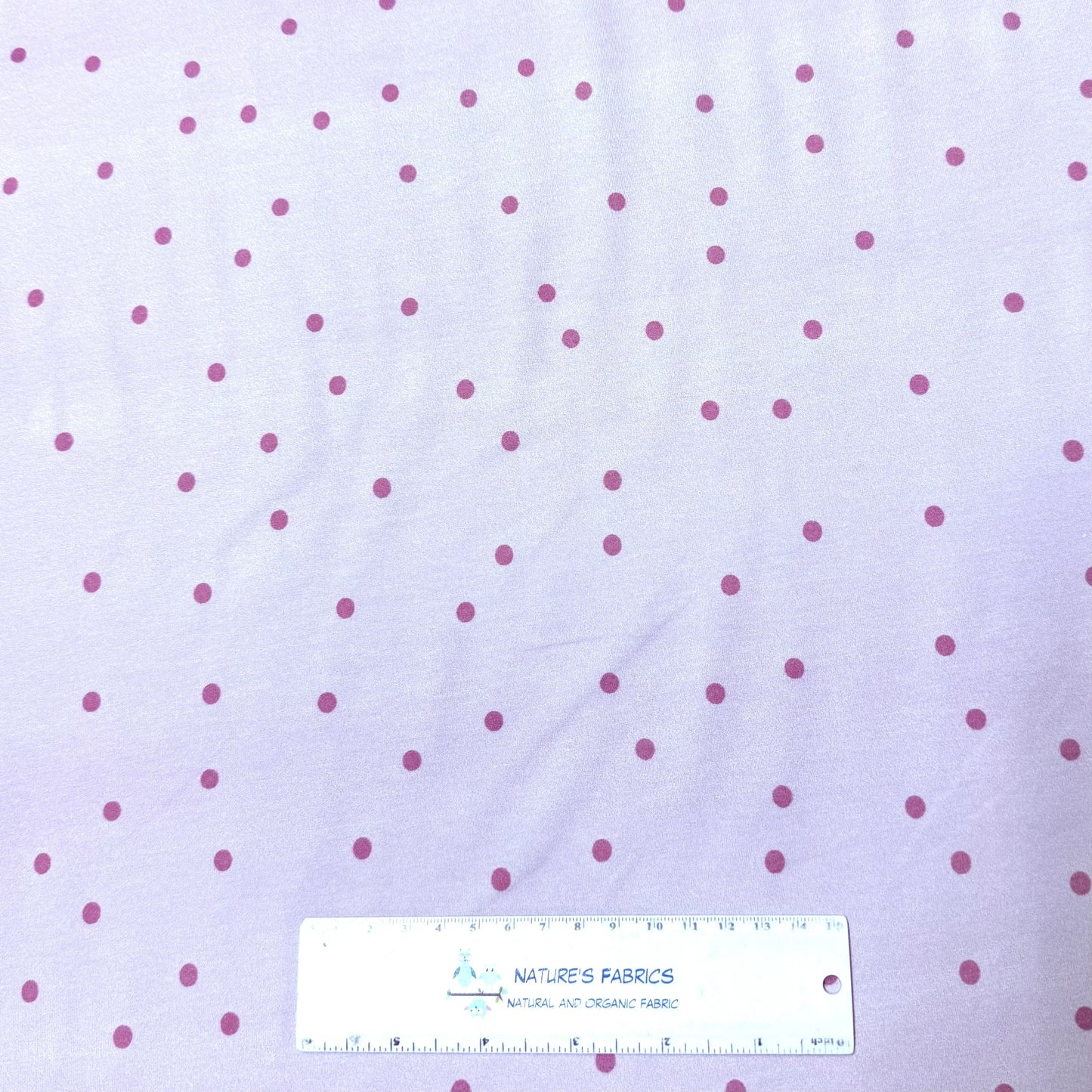 Lavender fabric with pink polka dots by Nature's Fabrics, natural organic cotton yardage with ruler for scale