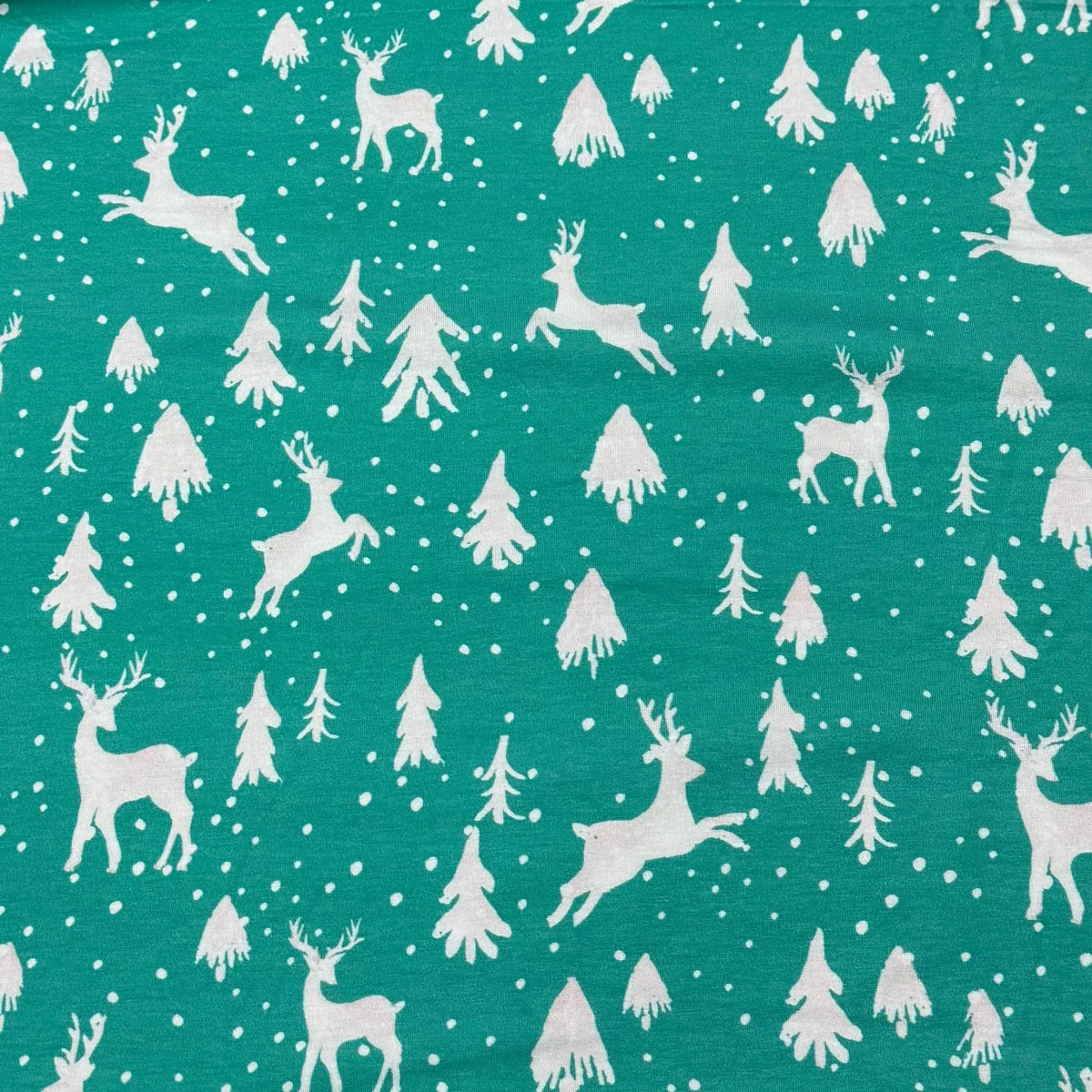 Teal fabric with white reindeer and snowflakes pattern by Nature's Fabrics