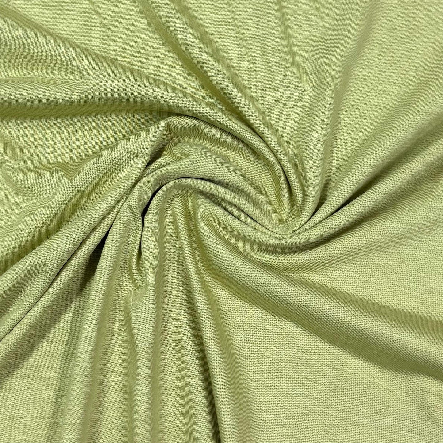Soft green organic cotton fabric by Nature's Fabrics, ideal for eco-friendly sewing projects
