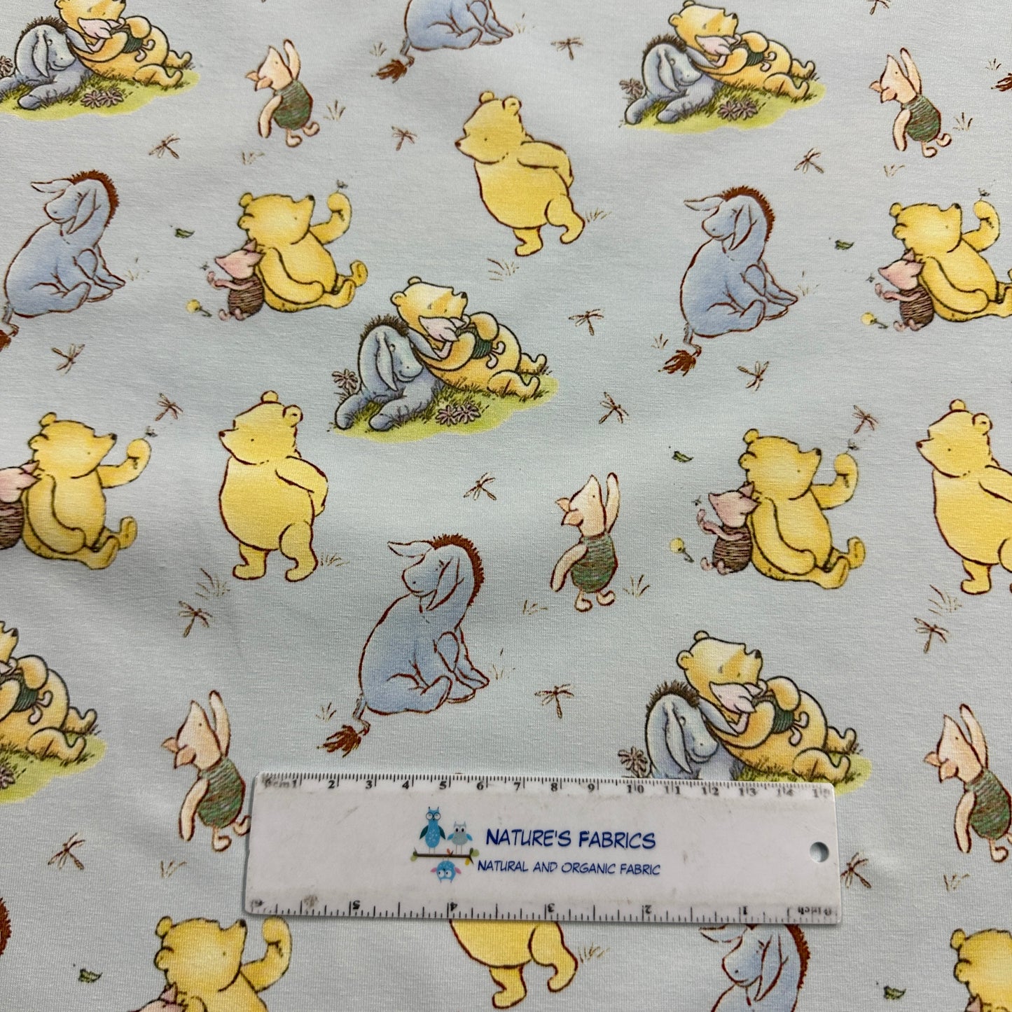 Winnie the Pooh and Friends on Blue Organic Cotton/Spandex Jersey Fabric