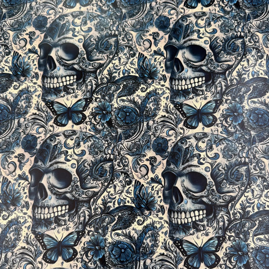 Nature's Fabrics blue and white skull and butterfly patterned fabric.