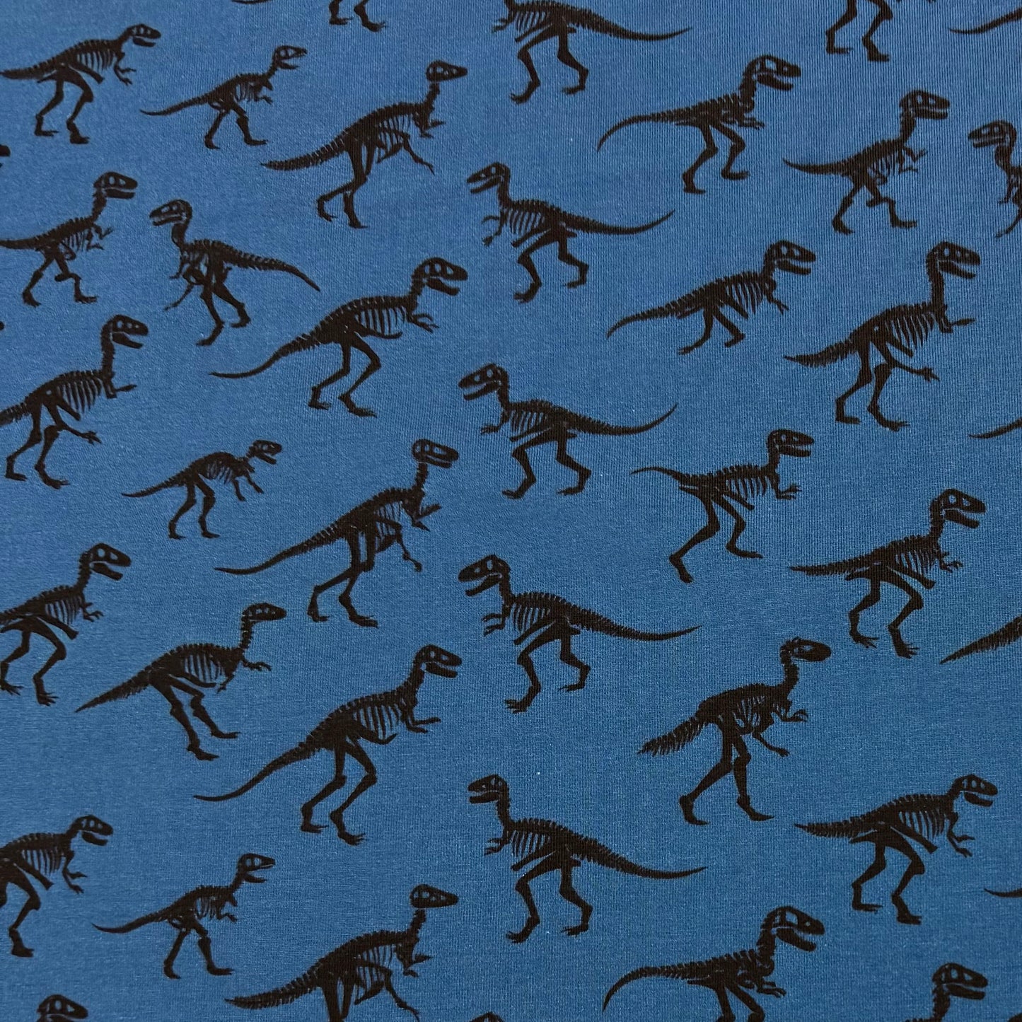 Black Dinos on Blue Organic Cotton/Spandex Jersey Fabric