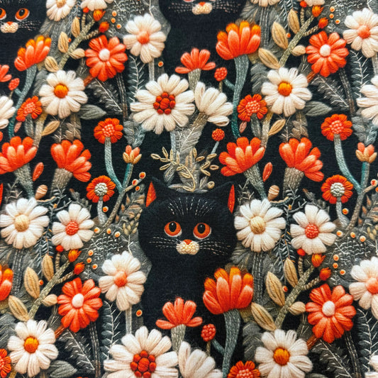 Nature's Fabrics embroidered black cat pattern with orange and white flowers on dark fabric