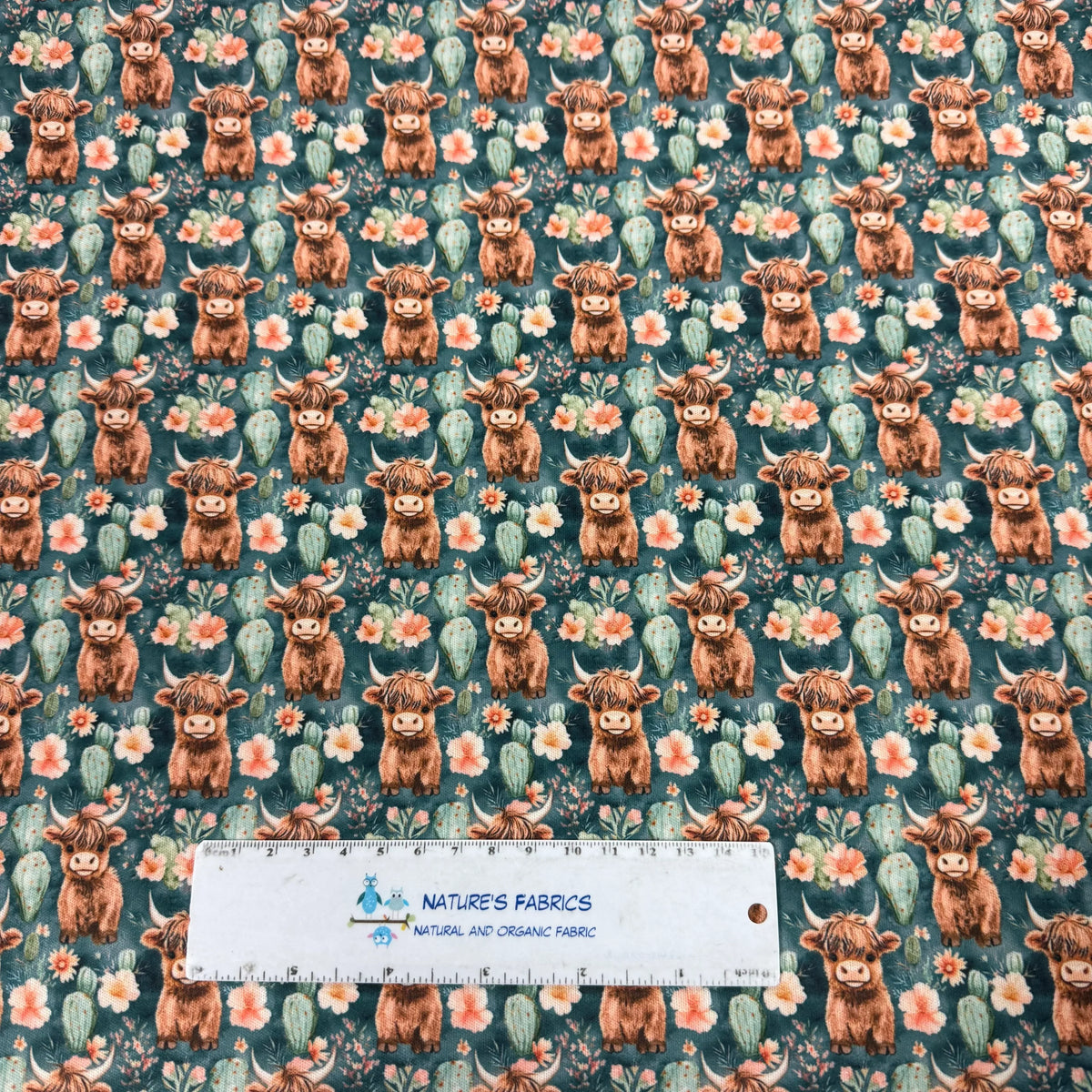 Nature's Fabrics organic cotton fabric with Highland cow, cactus, and floral print design