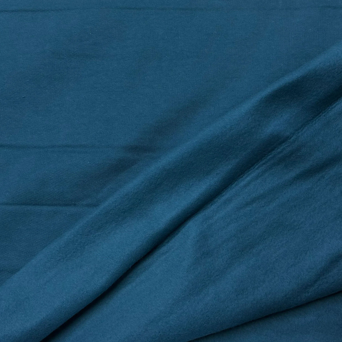 Deep teal organic cotton fabric by Nature's Fabrics, soft texture and natural drape for eco-friendly sewing projects