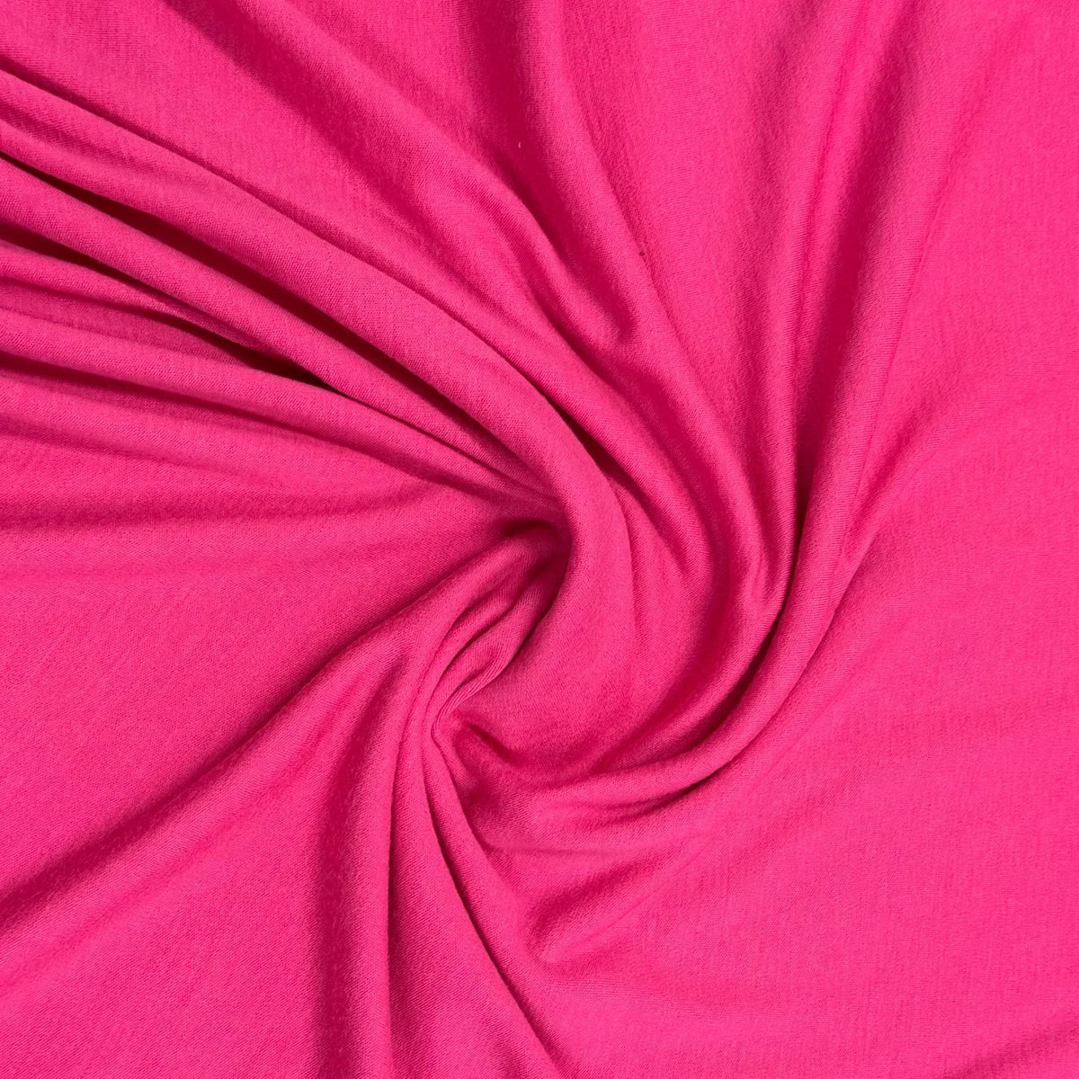 Vibrant pink organic cotton fabric swirled texture by Nature's Fabrics