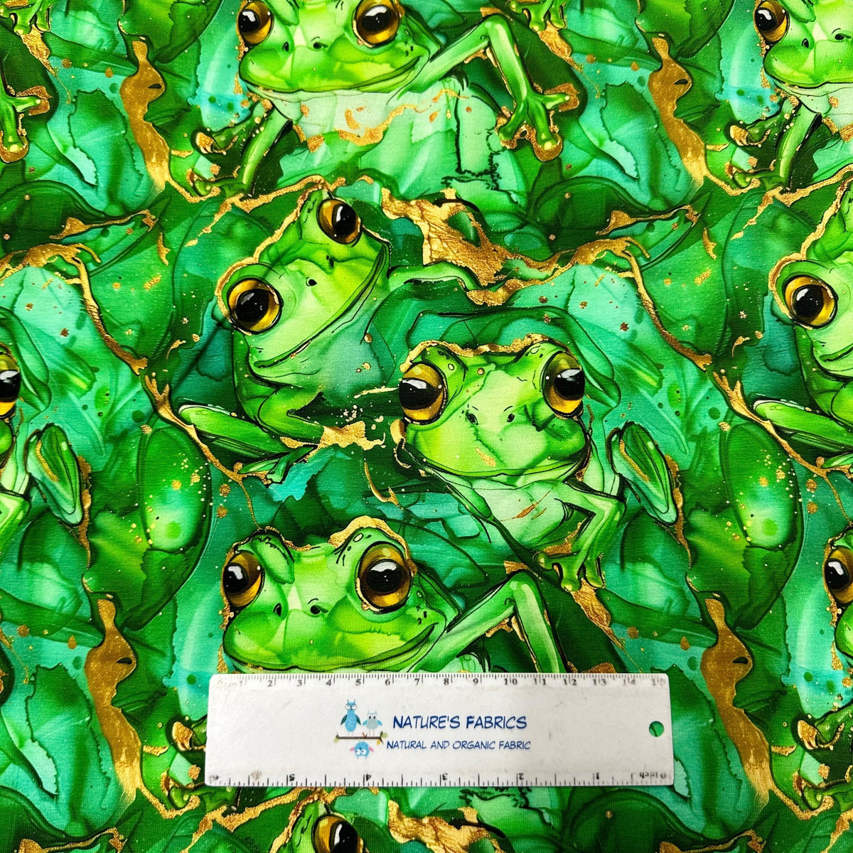 Green frog print fabric with gold accents by Nature's Fabrics, organic cotton material for quilting and crafts