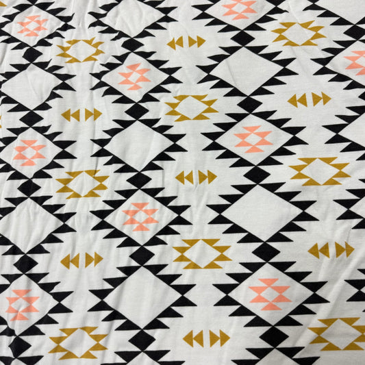 Nature's Fabrics white fabric with black, gold, and pink southwestern geometric patterns