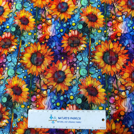 Nature's Fabrics colorful sunflower print organic fabric with a ruler for scale