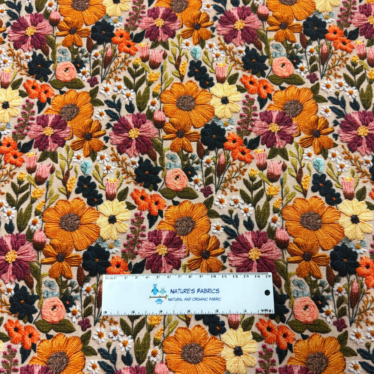 Nature's Fabrics floral embroidered organic fabric with colorful sunflowers and wild blossoms.