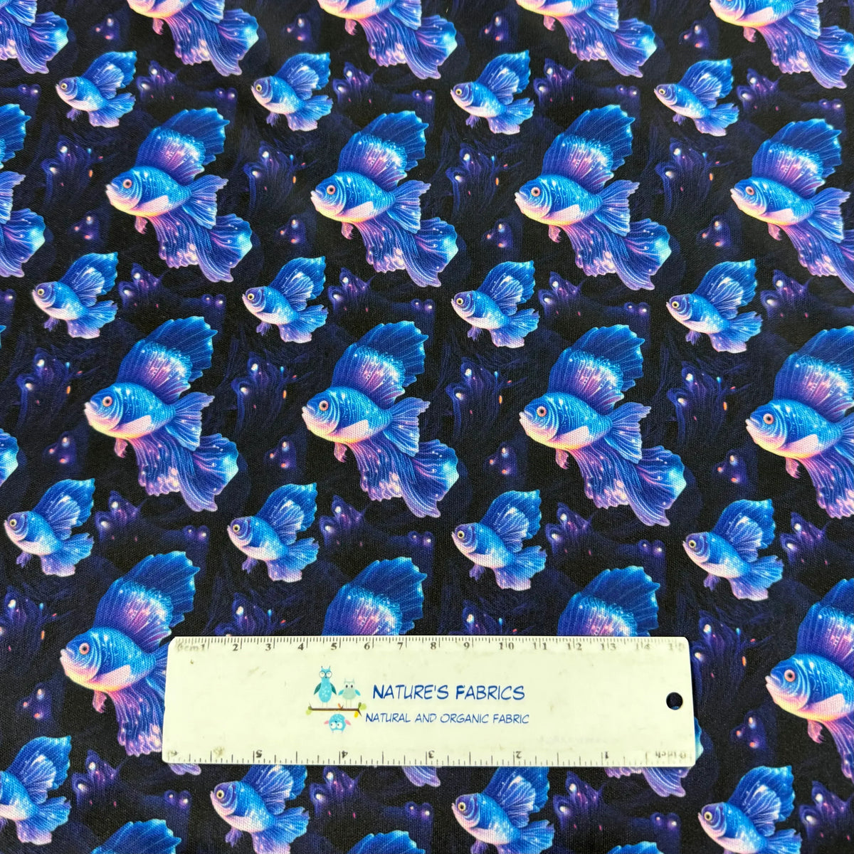 Nature's Fabrics blue betta fish print on black organic cotton fabric, ruler for scale