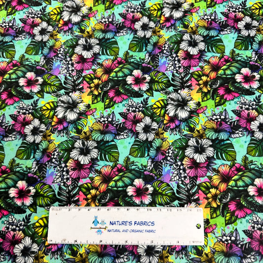 Nature's Fabrics colorful tropical floral print fabric with hibiscus and palm leaves.