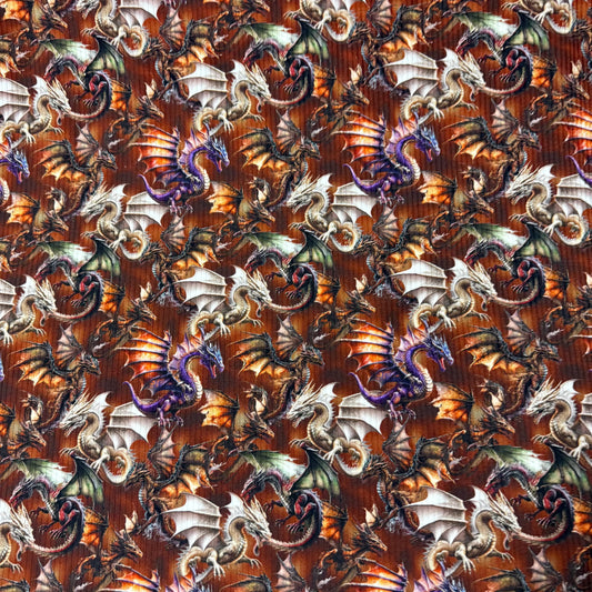 Nature's Fabrics dragon pattern fabric featuring colorful mythical dragons on a brown background
