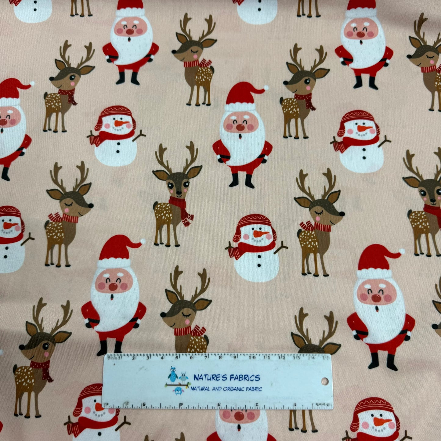 Christmas-themed fabric with Santa, reindeer, snowmen by Nature's Fabrics
