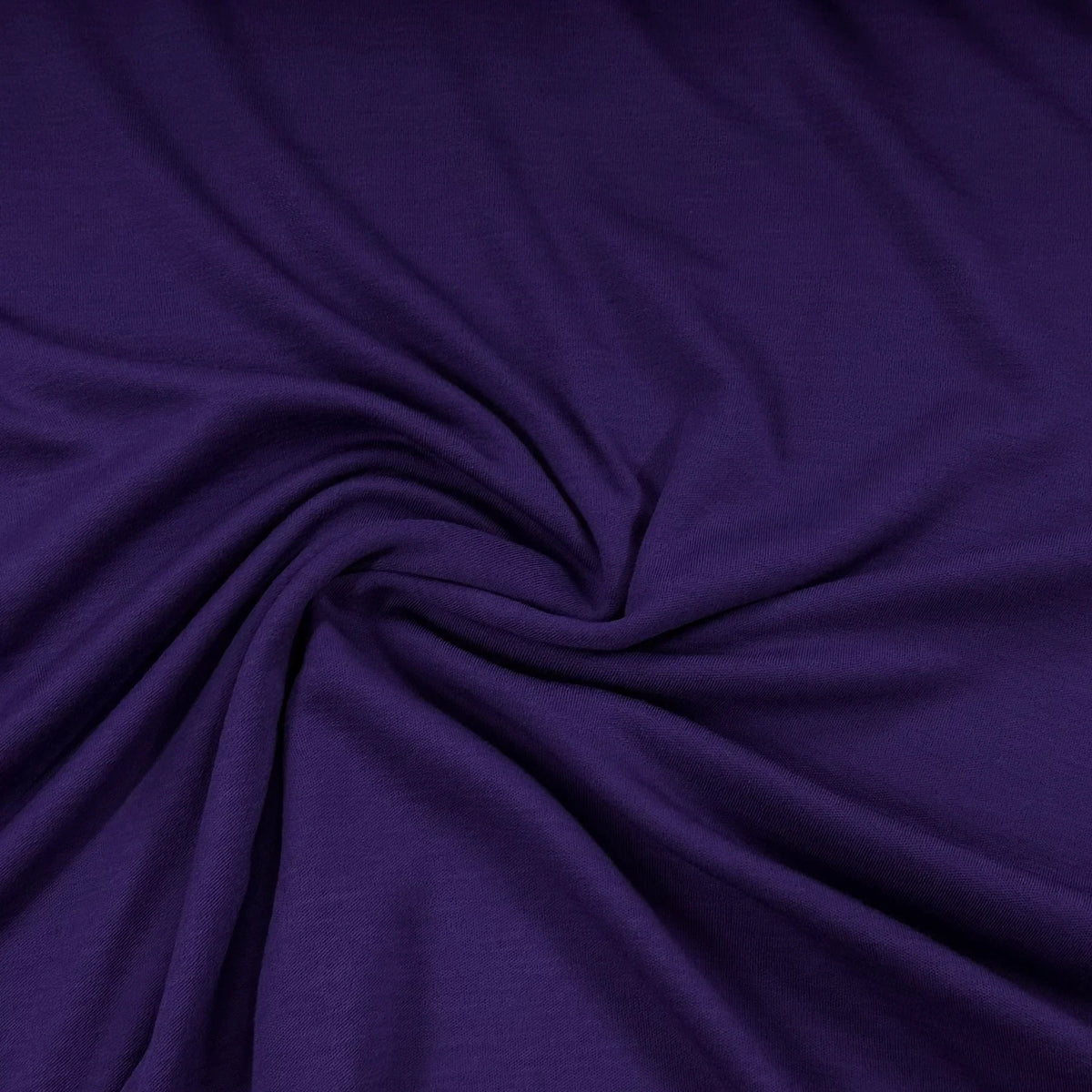 Deep purple premium natural fabric draped in soft swirls from Nature's Fabrics.
