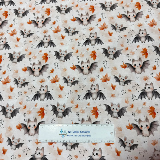 Nature's Fabrics organic cotton fabric with a pattern of cute bats and autumn leaves.