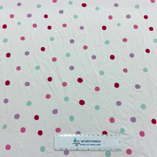 Nature's Fabrics white organic cotton fabric with colorful pastel polka dots.