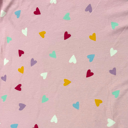 Nature's Fabrics pink organic cotton fabric with multicolored heart print