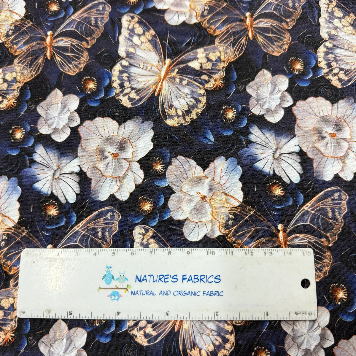 Nature's Fabrics butterfly and floral print organic cotton fabric with ruler for scale