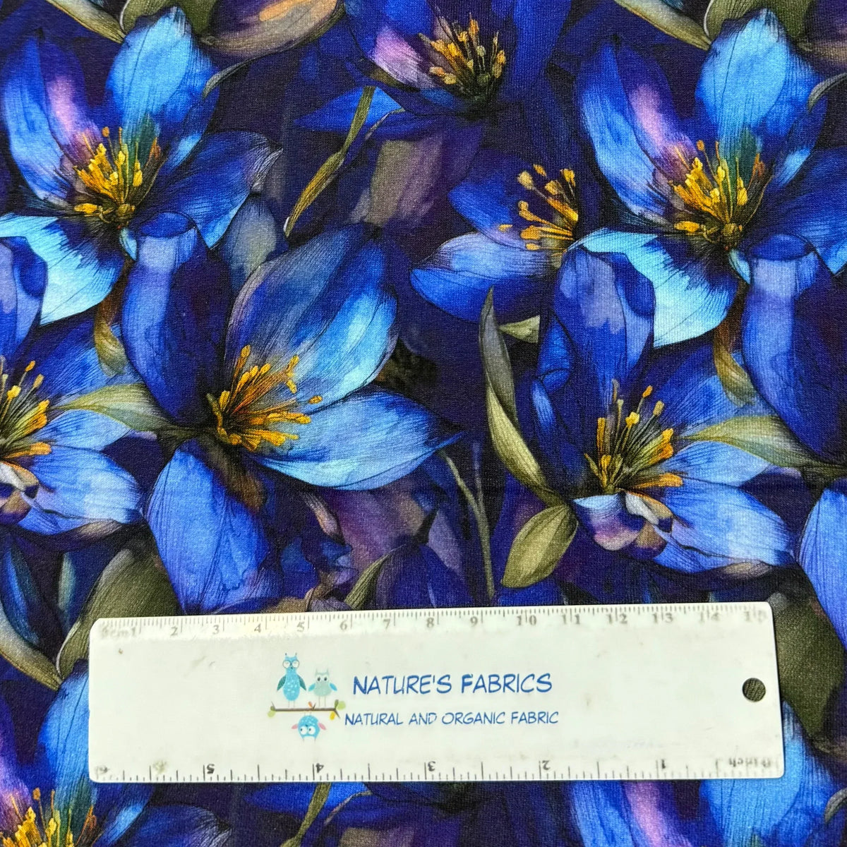 Nature's Fabrics blue floral print organic cotton fabric with ruler for scale, natural and eco-friendly textile